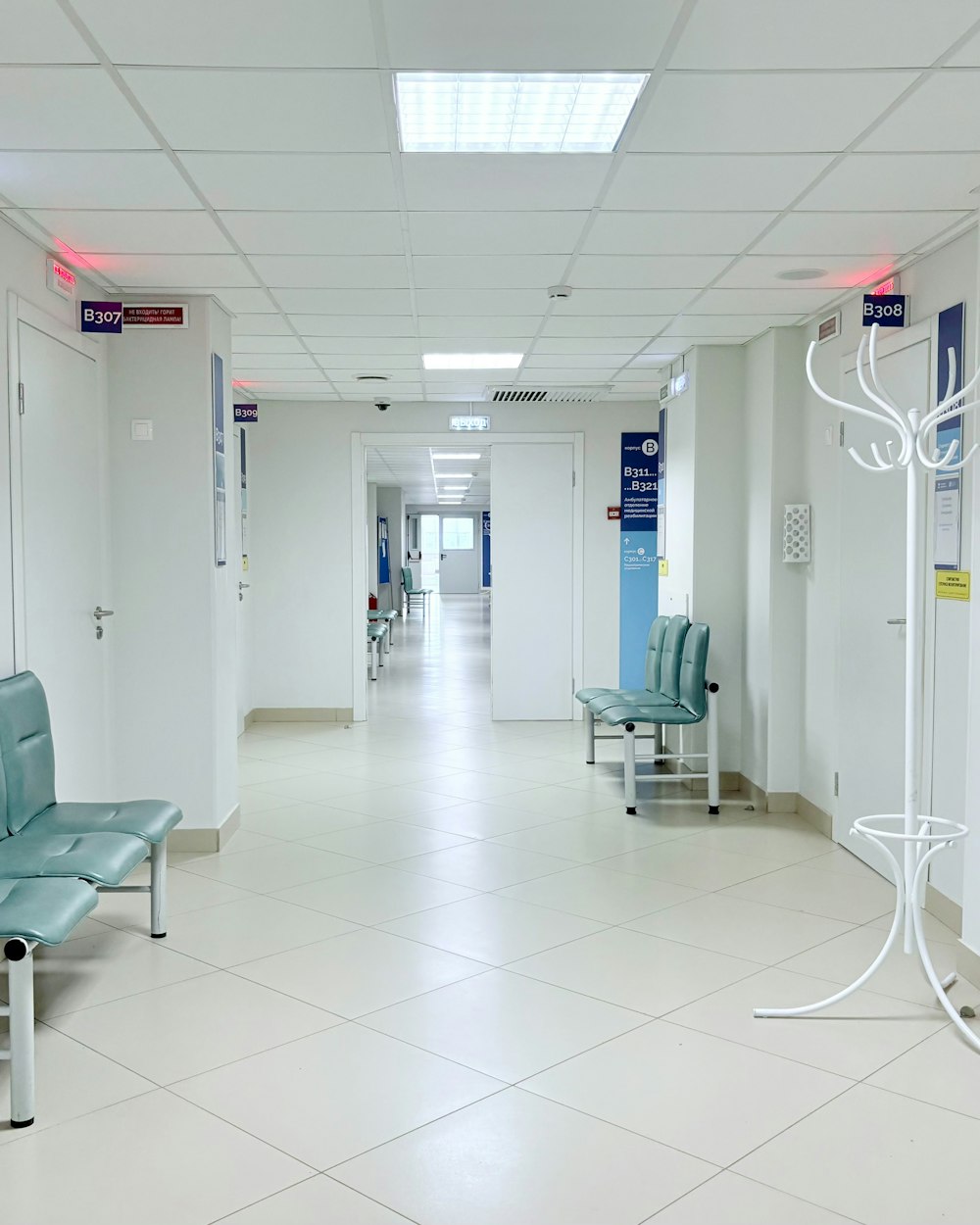 An empty hospital corridor with benches along the wall (illustrative stock photo)